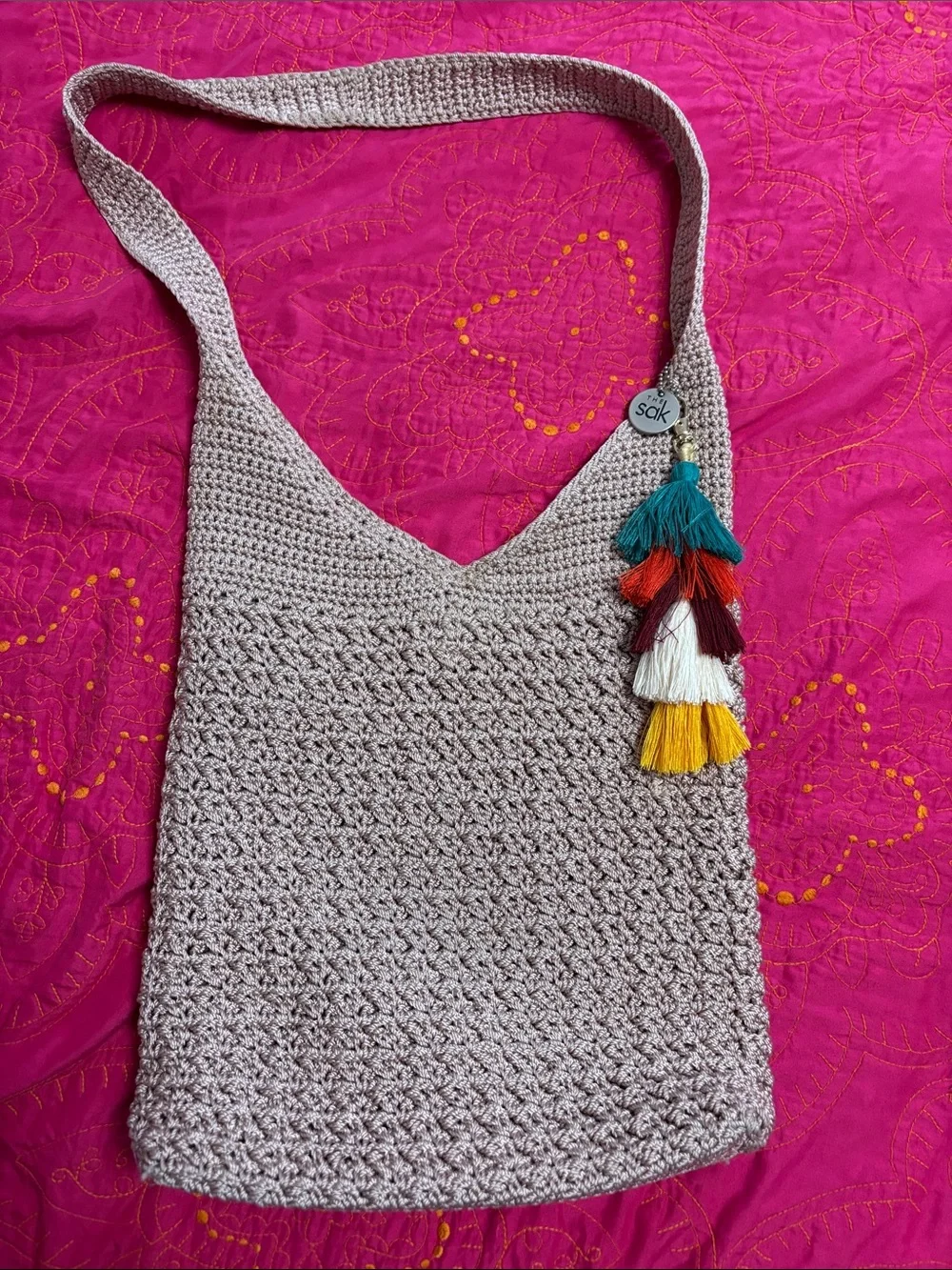 The Sak Crochet Satchel in Beige with Teal, Red, White & Yellow Tassels